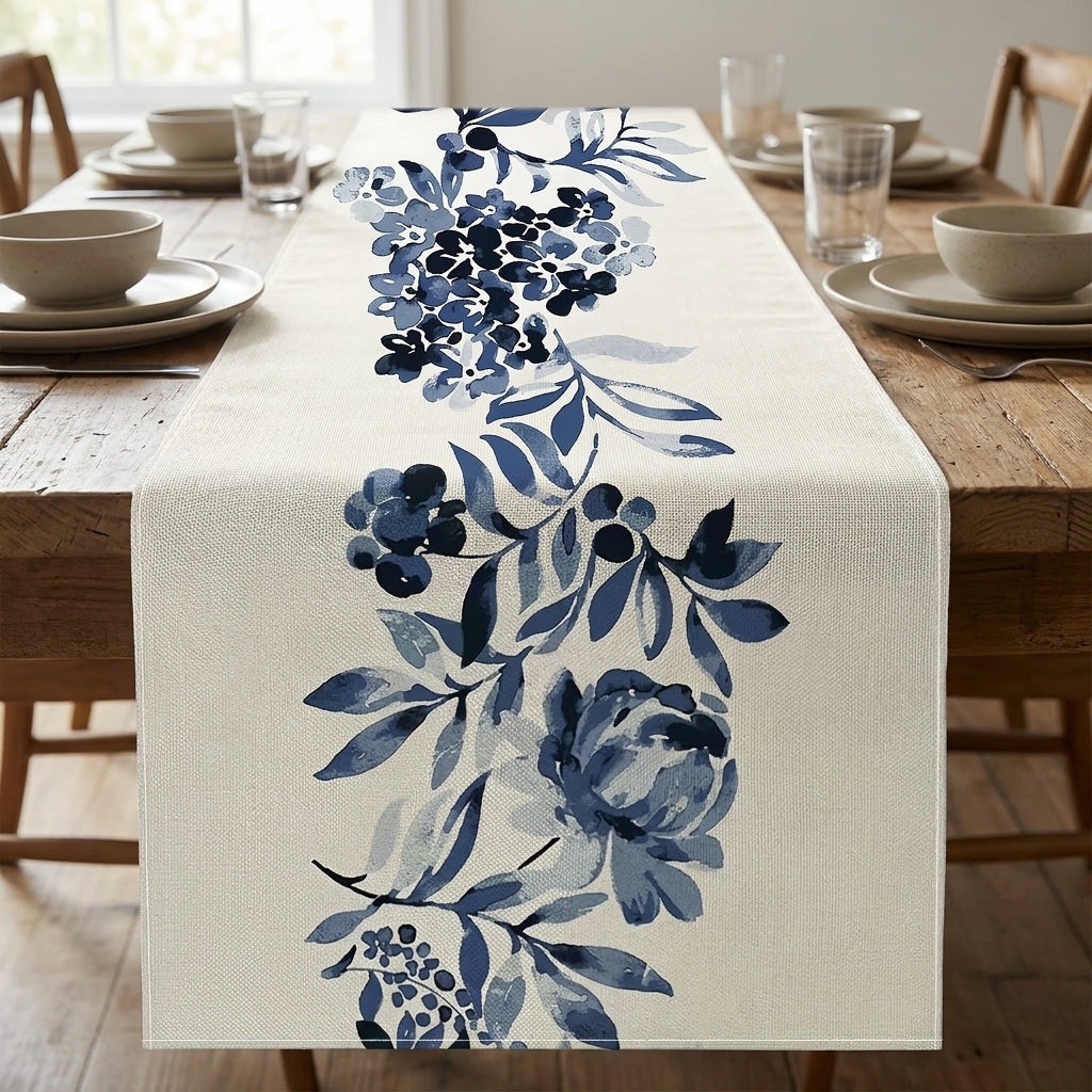 Cream linen table runner with blue floral watercolor print styled on a rustic wooden dining table