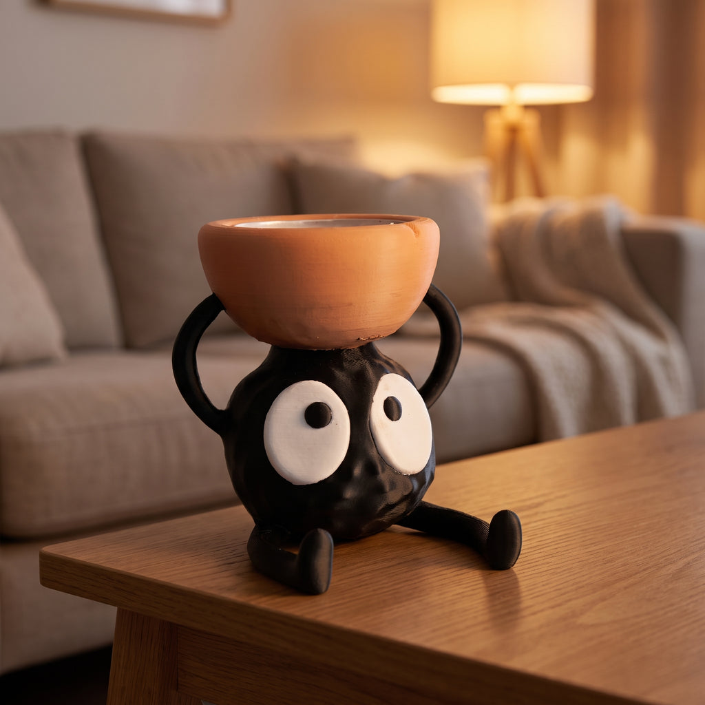 Cute briquette-shaped candle holder with googly eyes and a terracotta bowl on top, styled on a wooden side table in a warmly lit living room